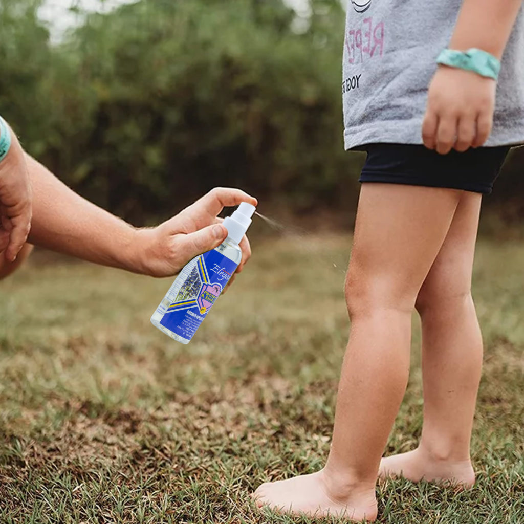 mosquito repellent applied to a young boy wearing shorts in open space