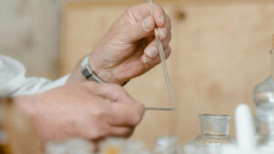 Hands preparing a diffuser to explore fragrance brain connection.